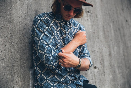 Man wearing a patterned ocean blue collared shirt